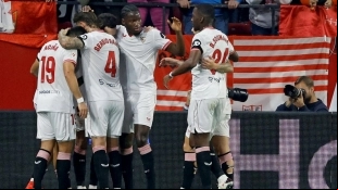 Sevilla players celebrate a goal